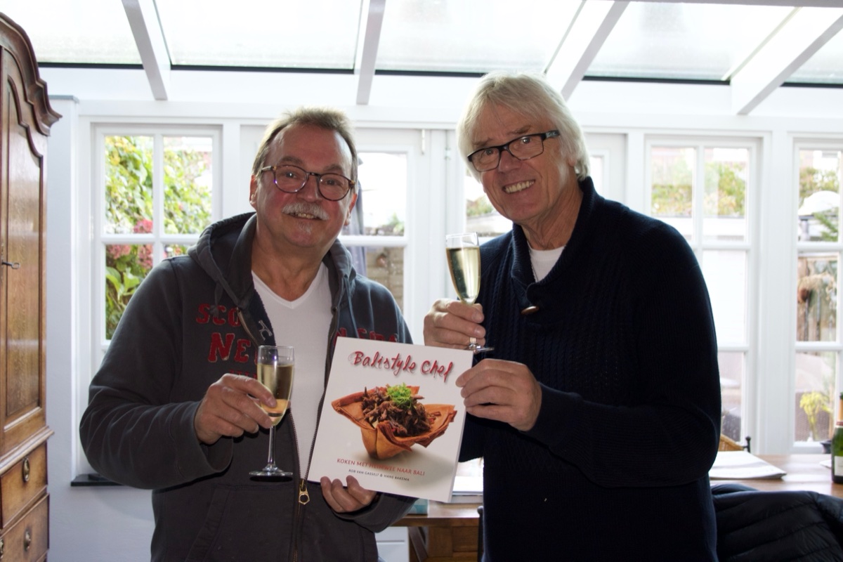 Rob van Gasselt en Hans Bakema proosten met bubbels op hun kookboek Balistyle Chef